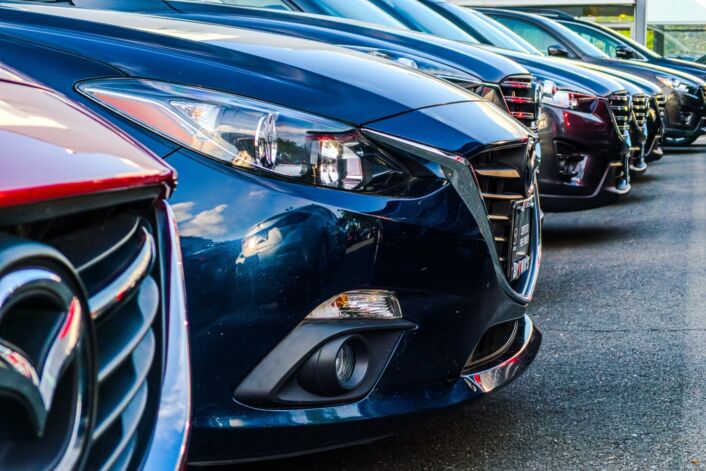 New cars and used cars lined up in a row