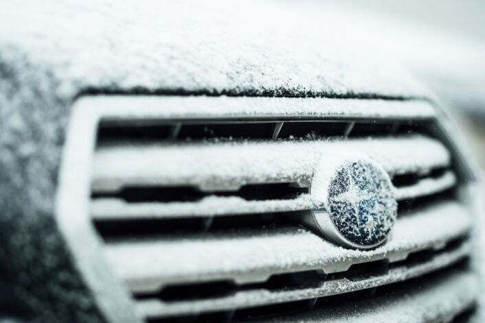 The front of a car frosted over in winter